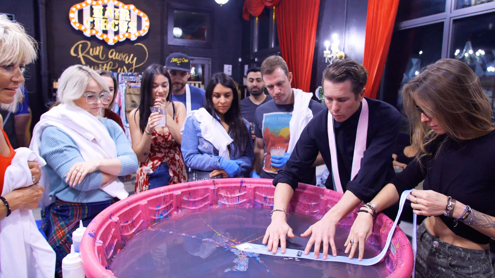 People gathered around the marbling bath at a Marbles dye session