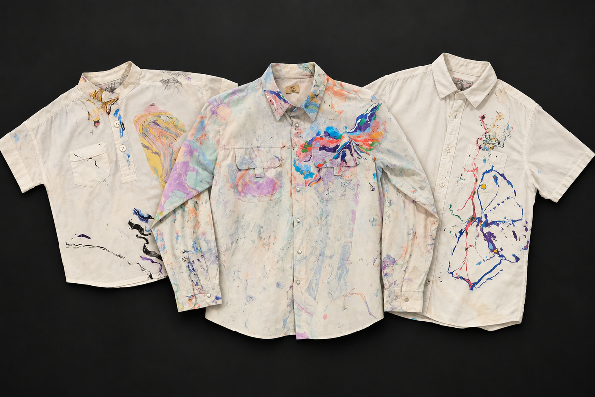 Three original Marbles shirts arranged on a matte black background