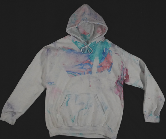A white hoodie, featuring a marbled multicolor dip dye.